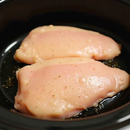 Place the boneless skinless chicken breasts in the crockpot